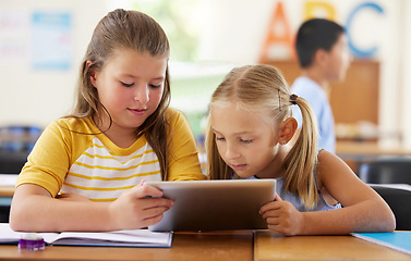 Image showing Tablet, friends and girls in classroom for education, elearning and online knowledge. Kindergarten, technology and kids or students with touchscreen in preschool for studying and watching together.