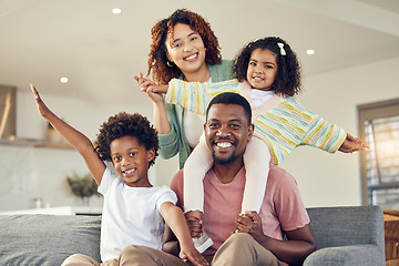 Image showing Happy family, piggyback and portrait of kids with parents on a sofa, smile and cheerful while bonding in their home. Airplane, fun and face of children with mother and father in living room together