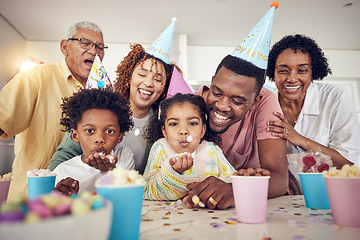 Image showing Birthday party, blow and confetti with family in kitchen for celebration, bonding and affectionate. Happy, excited and grandparents with parents and children at home for surprise, fun or event