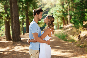 Image showing Happy couple, hug and outdoor forest road of young people showing love for engagement announcement. Woods, trees and care of a woman and man together on holiday in nature with a smile and happiness