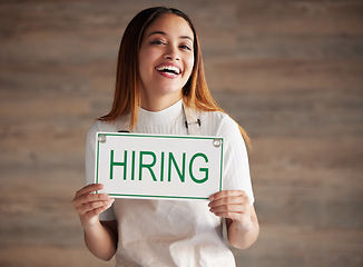 Image showing Woman, portrait and hiring sign for small business recruitment, career or job opportunity against a studio background. Happy female entrepreneur with apron holding billboard poster for hire on mockup