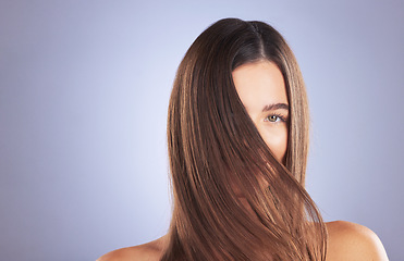 Image showing Woman, beauty and hair portrait in studio for space, growth and healthy shine on blue background. Aesthetic female model for haircare texture, self care and cosmetic results for salon or hairdresser