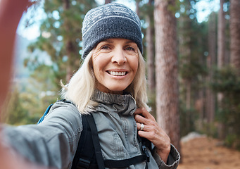 Image showing Selfie, hiking and a senior woman in the forest for fitness, adventure or the exploration of nature. Portrait, travel and exercise with a mature female hiker in the mountains or woods for a hike