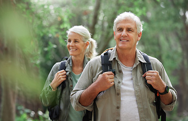 Image showing Hiking, elderly couple and active seniors in a forest, happy and relax while walking in nature. Senior, backpacker and woman with man outdoors for travel, freedom and healthy lifestyle in retirement