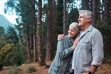 Image showing Hug, hiking and senior couple in forest, workout and quality time outdoor, happiness and wellness. Romance, mature man and old woman in woods, walking and fitness for healthy lifestyle and nature