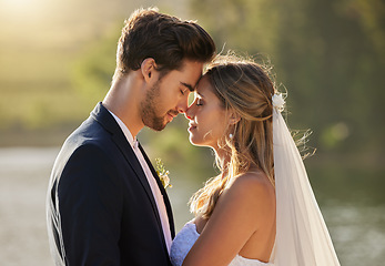 Image showing Couple, wedding and forehead by lake on romantic honeymoon or summer getaway together in nature. Married man and woman touching head for marriage, relationship or loving embrace in the outdoors