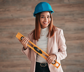 Image showing Architect, woman and portrait smile with level tool for measuring balance in construction planning. Happy female contractor, engineer or builder smiling with safety helmet equipment for architecture