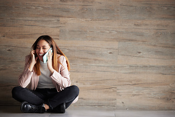 Image showing Woman, phone call and space for communication or connection in studio with advertising mockup. Happy female on wooden background laughing at funny conversation or listening and talking on smartphone