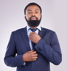 Image showing Portrait, business and black man fixing tie in studio isolated on a gray background. Ceo, entrepreneur and confident, proud or serious male professional from South Africa with pride for career or job