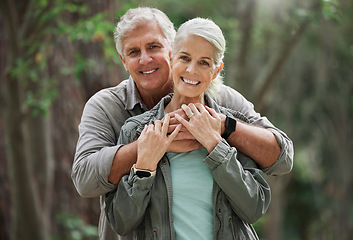 Image showing Hug, hiking and portrait of senior couple with smile on adventure in forest, woods and mountain for exercise. Fitness, retirement and happy elderly man and woman trekking, walk and hike for wellness