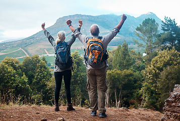 Image showing Hiking, mature couple and arms raised on cliff from back on nature walk and mountain in view in Peru. Travel, senior man and woman celebrate forest hike with love and achievement on holiday adventure