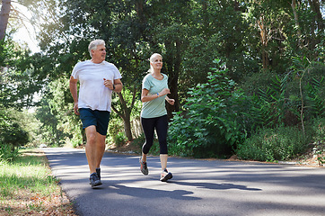 Image showing Fitness, senior and a couple running in a park for cardio, retirement exercise and movement. Happy, morning and an elderly man and woman jogging for health, training and active together in nature