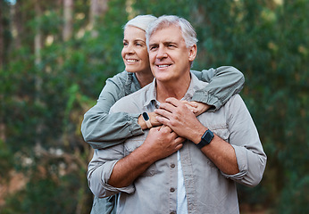 Image showing Senior couple, hiking and hug outdoor in nature for exercise, fitness and trekking for health and wellness. Old man and woman thinking, care and smile on forest hike for cardio workout in retirement