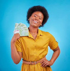 Image showing Black woman, money fan and smile in studio for winning, finance goal and success by blue background. Girl, happiness and cash in hand from casino, gambling and winner with wealth, rich and proud