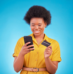 Image showing Credit card, happy black woman and mobile in studio for ecommerce payment, fintech money and online shopping. Female model, smartphone banking and finance on internet, technology and retail customer