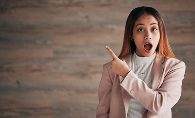 Image showing Shocked woman, portrait and pointing on mockup for announcement, advertising or marketing. Surprised business female point finger to copy space in shock for advertisement against a studio background