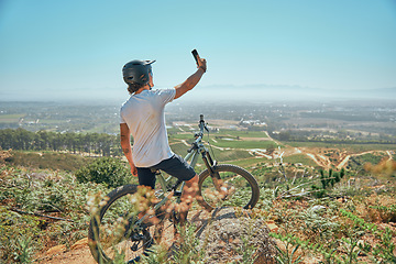 Image showing Fitness, selfie and man on a bicycle with phone for cycling, photography or photo in nature. Cyclist, workout and social media health influencer live streaming for blog, website or profile picture