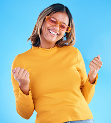 Image showing Fashion celebration, excited or happy woman, studio winner and celebrate victory, luxury designer brand or casual outfit style. Success, winning achievement and gen z female cheers on blue background