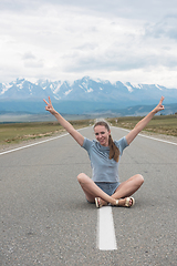 Image showing Woman sitting on the road