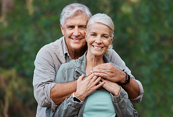 Image showing Love, portrait and elderly couple hug in a forest for hiking, relax and walking in nature on blurred background. Face, embrace and happy senior man with woman on retirement vacation in the woods