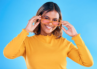 Image showing Fashion, happy portrait or woman smiling with glasses, designer brand style or casual summer outfit. Gen z aesthetic, trendy sunglasses accessory or female face model on blue background studio