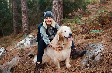 Image showing Adventure, explore and woman hiking with her dog, pet or animal in the winter forest for exercise, workout or fitness. Trekking, travel and elderly or senior female trekking in the woods on holiday