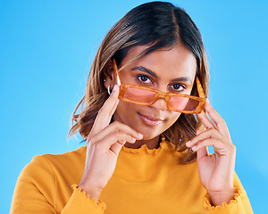 Image showing Fashion, portrait and studio woman with sunglasses, designer brand style or casual summer outfit. Young gen z aesthetic, trendy glasses accessory and face of stylish female model on blue background