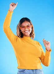 Image showing Fashion celebration, portrait dance and happy woman, studio winner and celebrate victory, happiness or freedom. Winning achievement success, excited dancing and gen z female cheers on blue background