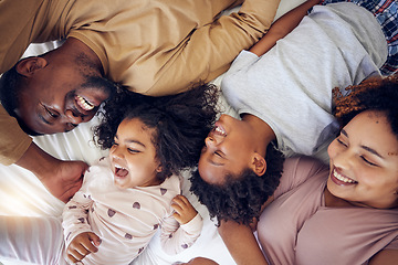 Image showing Happy, above and family laughing in bed, smile and bonding while resting in their home. Top view, smile and children waking up with mother and father in a bedroom, playful and having fun