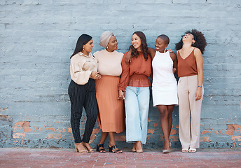 Image showing Laughing, diversity and a team of business black women outdoor on a blue brick wall for conversation. Talking, joking or bonding with a female employee and colleague group taking a break outside