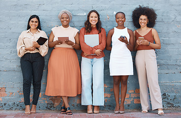 Image showing Portrait, group and business women smile on brick wall with devices or gadgets in city. Technology, cooperation and teamwork, diversity or collaboration of friends, people or employees with happiness