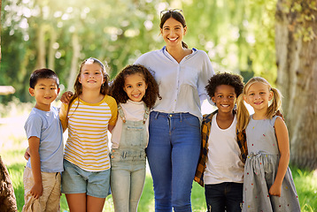 Image showing Portrait, teacher smile and children outdoor in nature for holiday, vacation or learning. Education, happiness and group diversity of students with woman at summer park or garden having fun together.