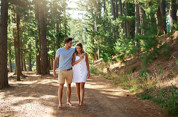 Image showing Couple take a walk in forest, nature and travel, relax together with hug outdoor, love with care and bonding. Summer, holiday with man and woman strolling in countryside with relationship and trust