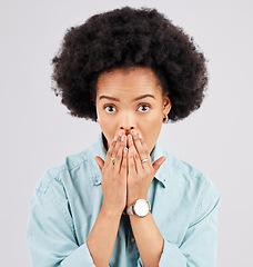 Image showing Portrait, hand and mouth with a shocked woman in studio on a gray background feeling surprised by gossip. Face, wow or afro and a young female hearing news with an omg or wtf expression of disbelief