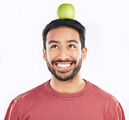 Image showing Smile, apple and man in studio for diet, nutrition and balance with healthy breakfast on white background. Fruit, weight loss and asian guy nutritionist with organic, clean and fiber detox isolated