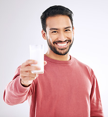 Image showing Milk, man and smile portrait with happiness in studio with calcium, healthy and nutrition drink. Isolated, white background and model feeling happy from weight loss, wellness and detox diet smoothie