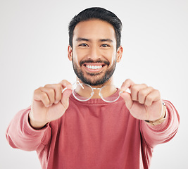 Image showing Glasses, man smile and portrait in a studio happy from vision and showing eyewear choice. Isolated, white background and happiness of an Asian male model with lens prescription and frame decision