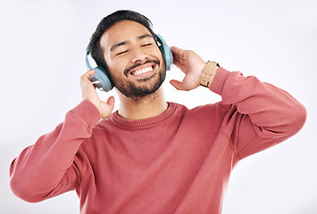 Image showing Headphones, moving and man doing a dance in studio to music, playlist or album for entertainment. Happiness, smile and Asian male model dancing to the radio or listening to a song by white background