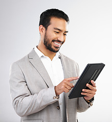 Image showing Smile, business and Asian man with tablet, typing and connection isolated on a white studio background. Japanese male ceo, employee and entrepreneur with device, scroll and network for online reading