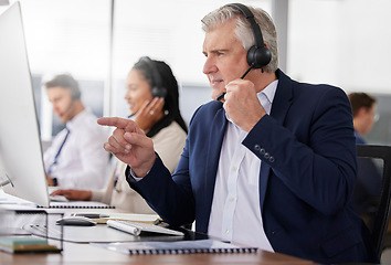 Image showing Man, call center and pointing to computer in office while working on customer service in workplace. Telemarketing, focus and mature person, male sales agent or consultant talking or consulting online