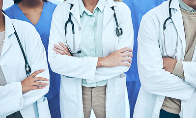 Image showing Hands, doctors and group with arms crossed in hospital or clinic for teamwork. Collaboration, nurses or confident medical professionals or people with pride for healthcare, wellness or diversity.