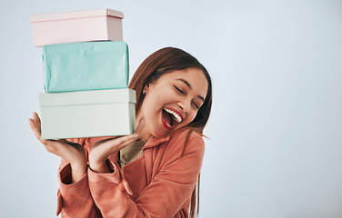 Image showing Gift box, excited and studio woman with shopping sales product, discount fashion deal or mall store present. Commerce market, retail person and happy customer celebrate on mockup grey background