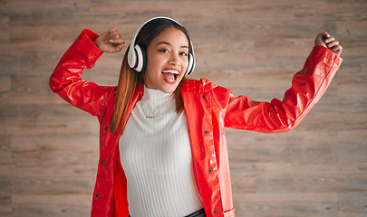 Image showing Woman, singing and dancing with music headphones isolated on a wood background. Happiness, dance and portrait of female, person or singer listening, streaming and enjoying audio, radio or podcast.