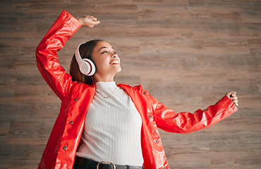 Image showing Woman, happiness and dancing with music headphones isolated on a wood background. Freedom, dance and female or person listening, streaming or enjoying audio, radio song or podcast, sound and smile.