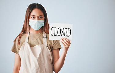 Image showing Woman, closed sign and face mask for covid in studio for announcement isolated on white background mockup. Entrepreneur, small business owner and closing poster for pandemic with portrait of waitress