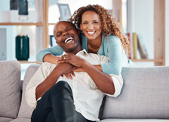 Image showing Couple, hug and laughing on sofa portrait in home living room, bonding and having fun. Interracial, love and funny black man and woman on couch embrace, happiness and enjoying quality time together.