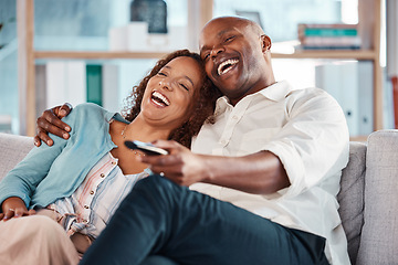 Image showing Couple, watching tv and laughing on sofa in home living room, bonding and hug. Interracial, television and funny black man and mature woman relax streaming comedy movie, comic film or meme video.