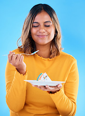 Image showing Woman, fork and cake in studio for dessert, satisfied or eyes closed for happiness by blue background. Indian model, girl and happy for eating sweets, snack and test flavor for food, meal and diet