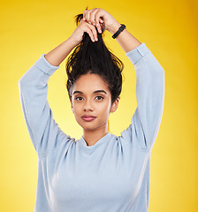 Image showing Portrait, hair care and beauty of woman in studio isolated on a yellow background. Natural, balayage and female model with long hairstyle growth, serious cosmetics and aesthetics for salon treatment