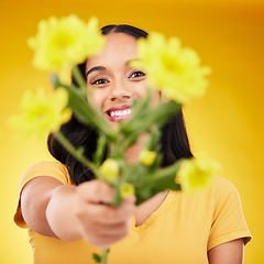 Image showing Happy, portrait and woman with flowers as a gift isolated on a yellow background in a studio. Floral, spring and girl giving a bouquet as a present, sharing plants and fresh flower with a smile